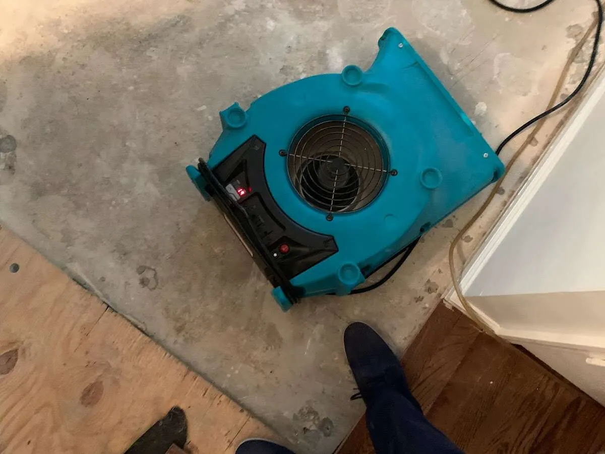 Air mover drying subfloor during Commercial Water Damage Restoration in Adelanto